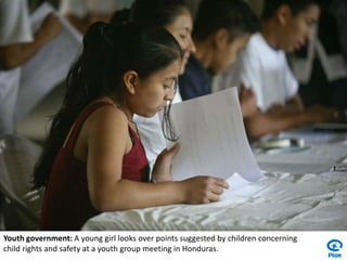 Youth government: A young girl looks over points suggested by children concerning child rights and safety at a youth group meeting in Honduras.
