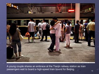 A young couple shares an embrace at the Tianjin railway station as train passengers wait to board a high-speed train bound for Beijing.  
