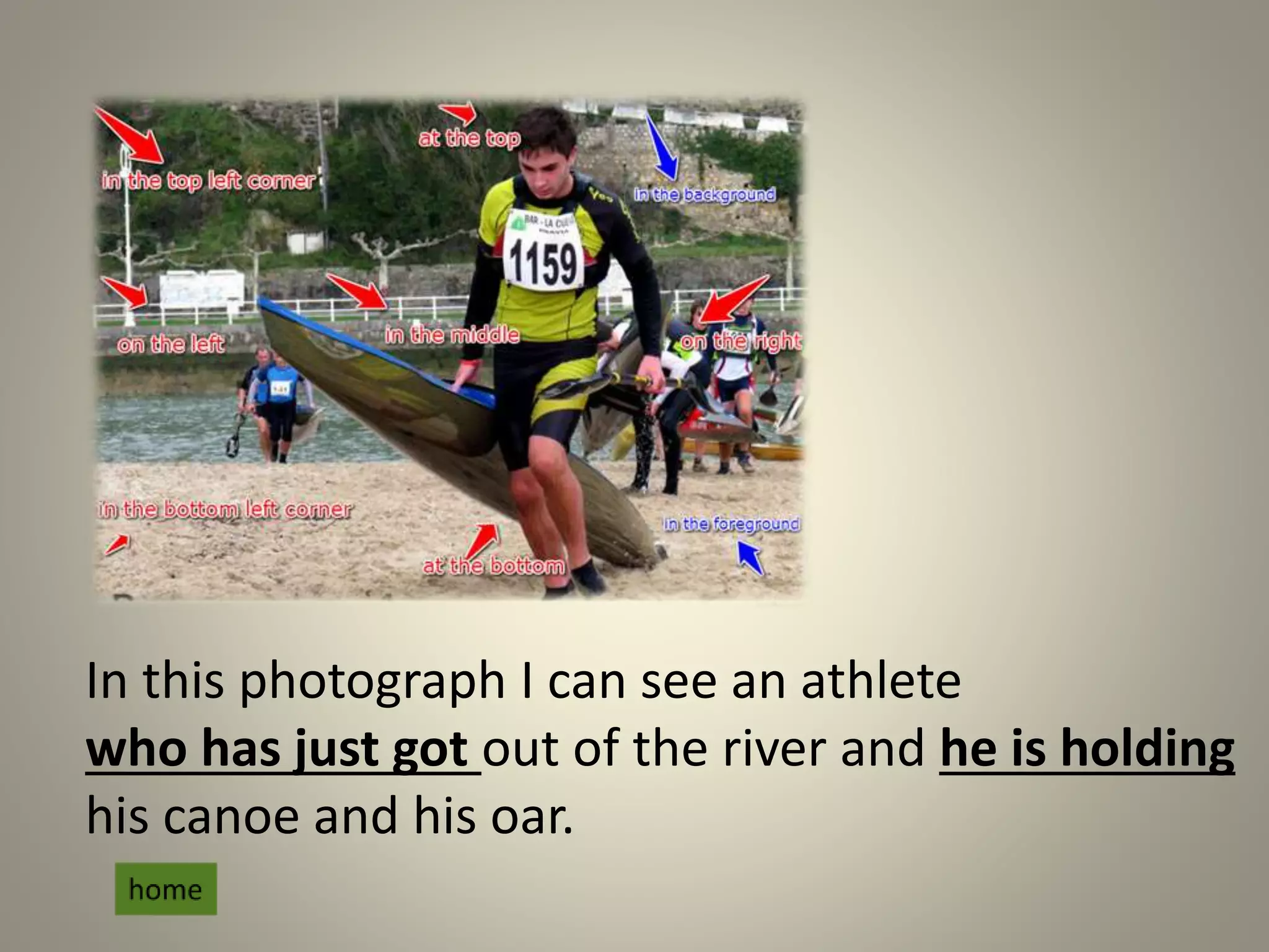 In this photograph I can see an athlete
who has just got out of the river and he is holding
his canoe and his oar.
 