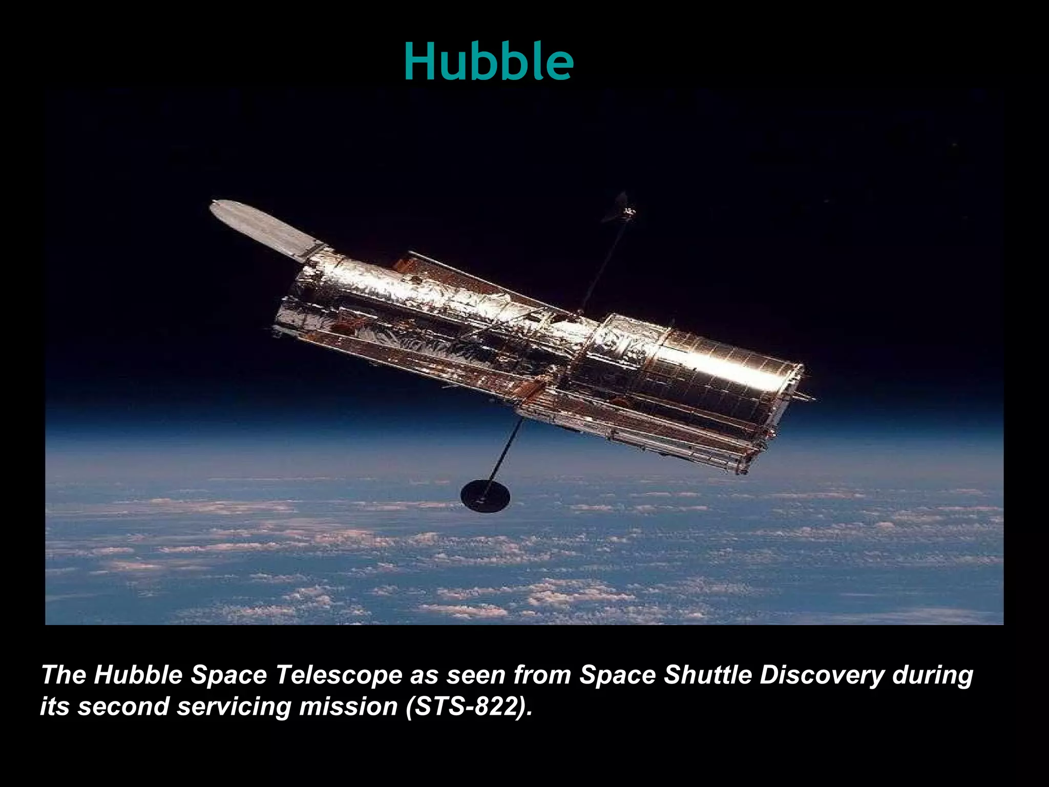 Hubble The Hubble Space Telescope as seen from  Space  Shutt le  Discovery during its second servicing mission (STS-82 2 ) .   