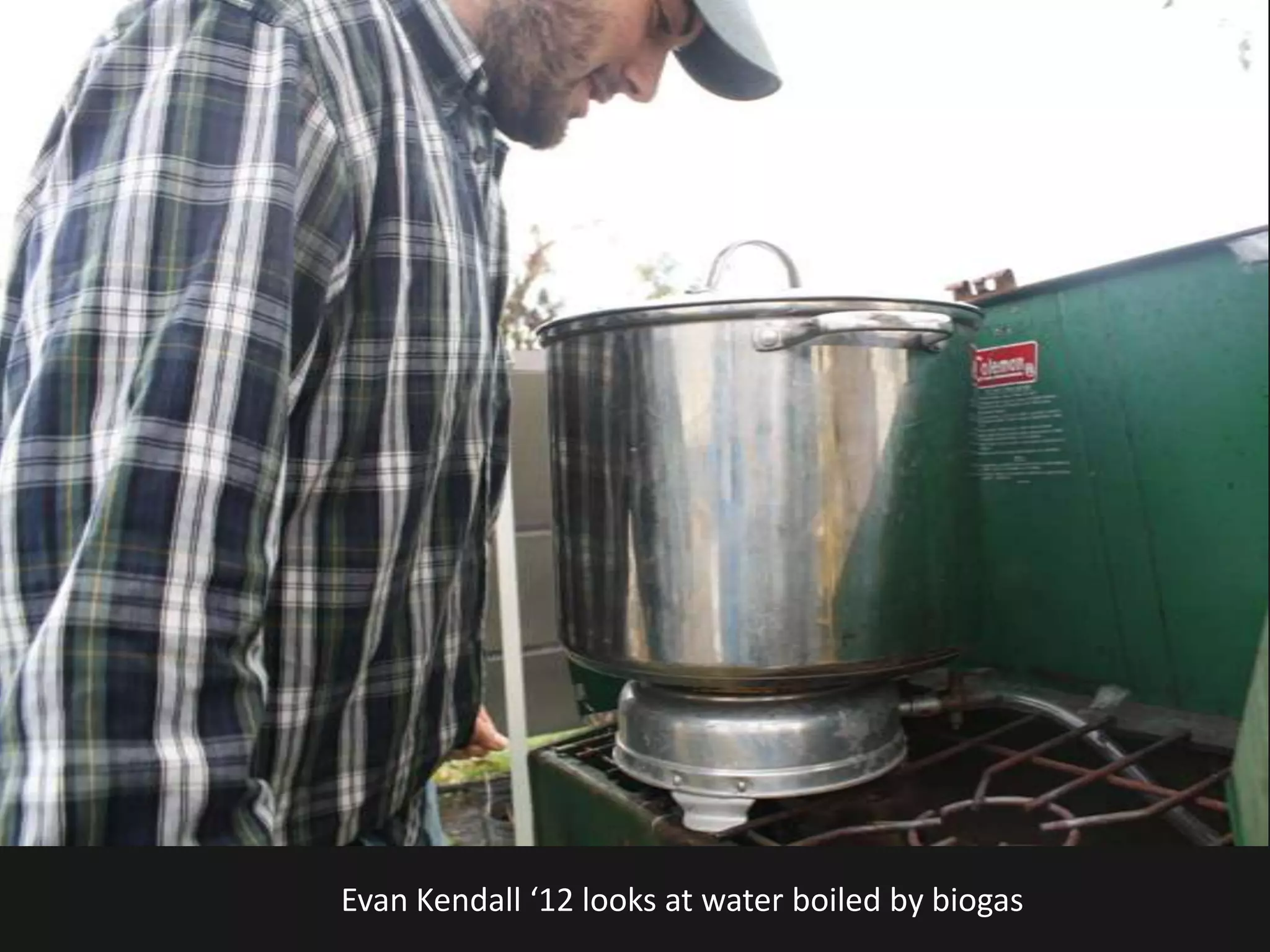 Evan Kendall ‘12 looks at water boiled by biogas
 