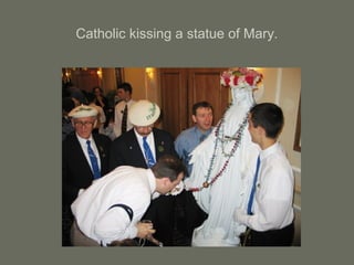 Catholic kissing a statue of Mary.
 