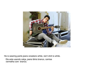 He is wearing  pan He is wearing pants jeans sneakers white, red t shirt is white. Ele esta usando calça, jeans tênis branco, camisa vermelha com  branco. 