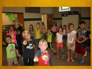 Kids smiling and pointing at
camera
 