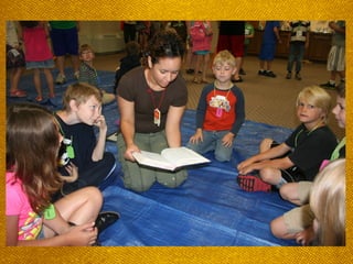 Child, surrounded by Crew
members, pointing to an open
Bible**
 