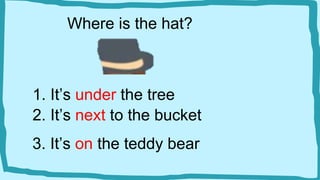 Where is the hat?
1. It’s under the tree
2. It’s next to the bucket
3. It’s on the teddy bear
 