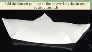 Fold the bottom point up so the tip overlaps the far edge
by about an inch
 