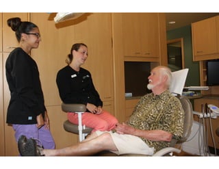 Dental hygienists at Current Dental Bainbridge Island explaining root canal treatment with patient