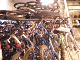 a pile of bikes + parts in the basement