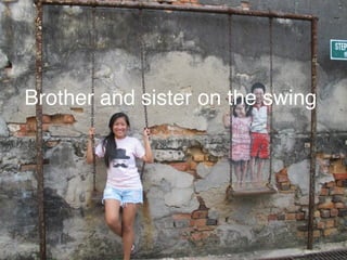 Brother and sister on the swing 
 