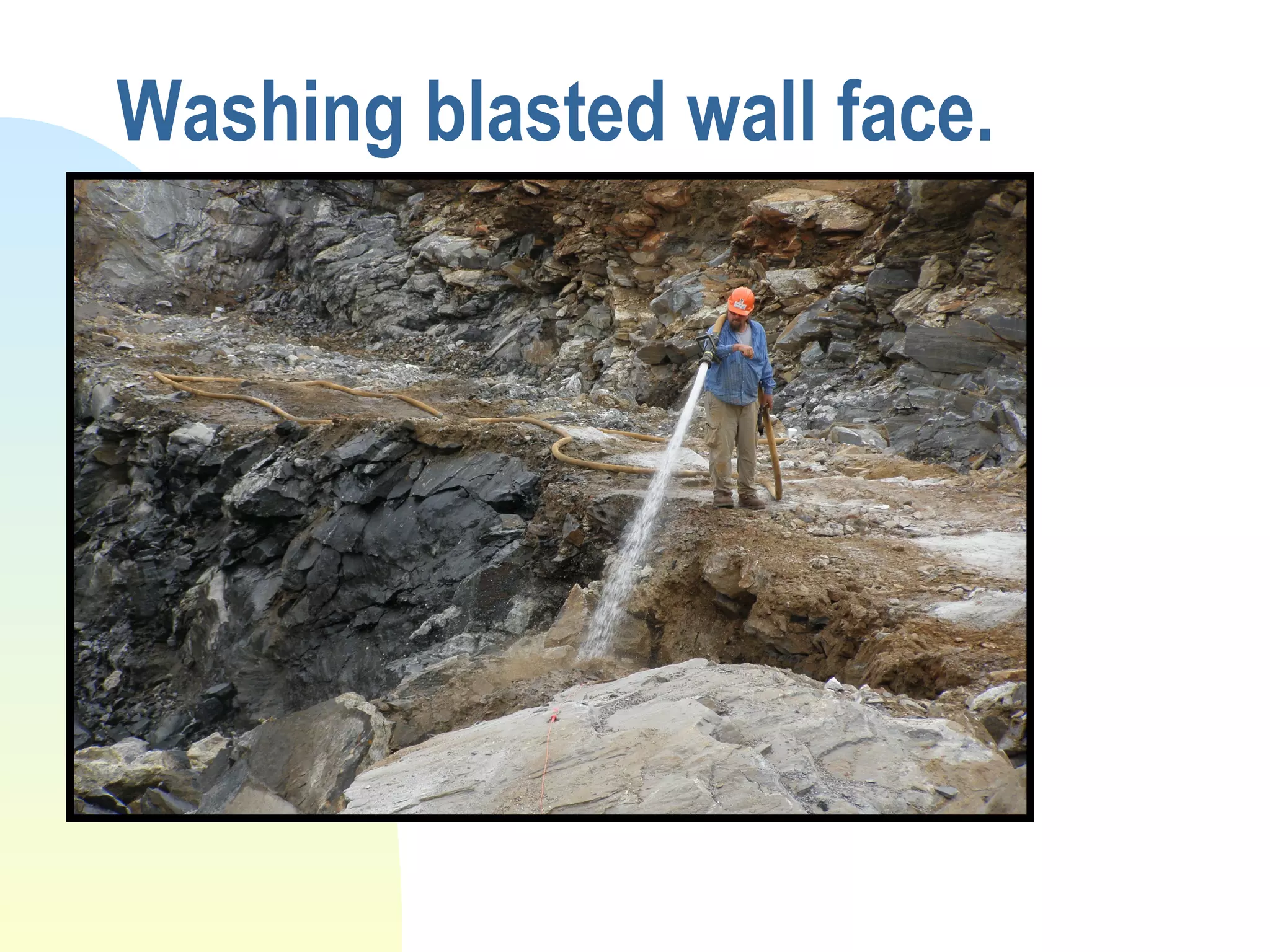 Washing blasted wall face.