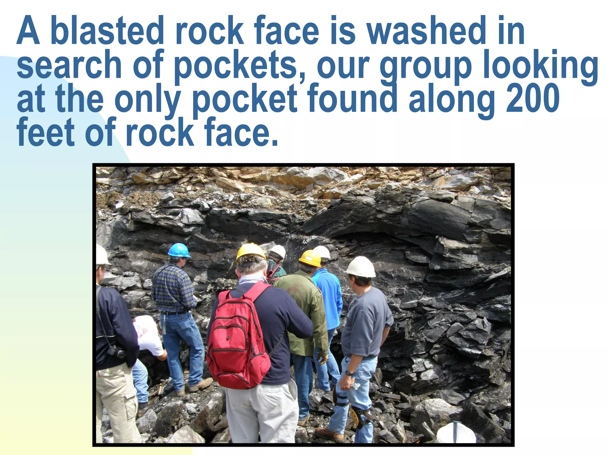 A blasted rock face is washed in search of pockets, our group looking at the only pocket found along 200 feet of rock face.