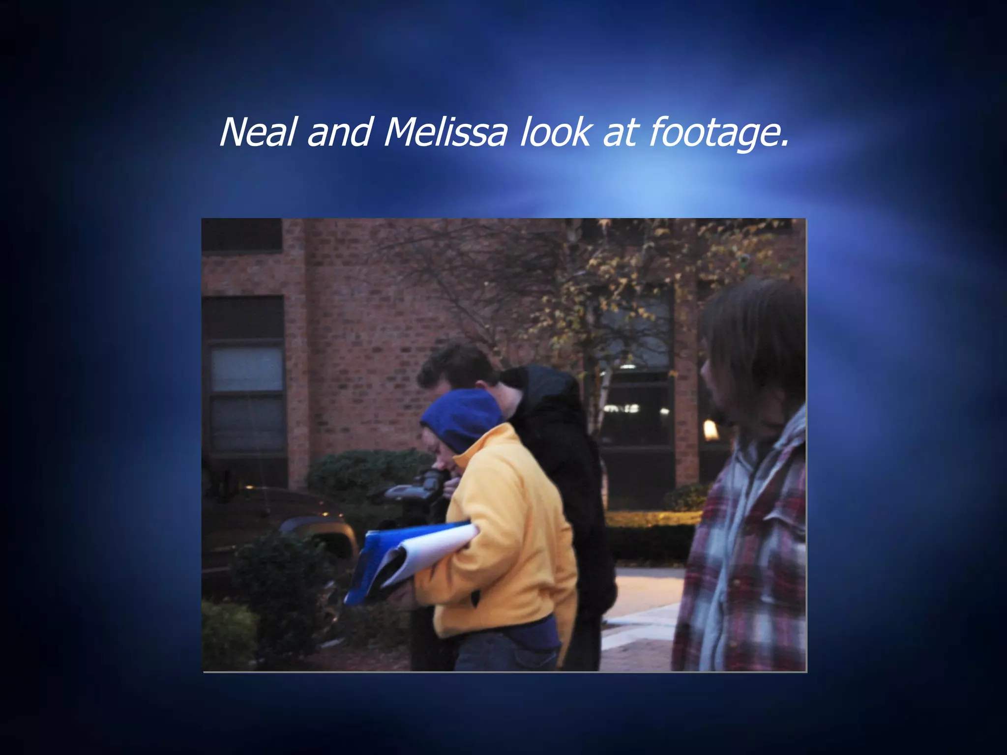 Neal and Melissa look at footage. 