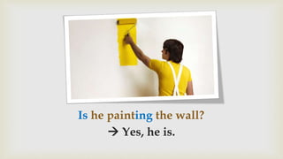 Is he painting the wall?
 Yes, he is.
 