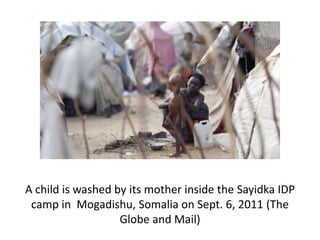 A child is washed by its mother inside the Sayidka IDP
 camp in Mogadishu, Somalia on Sept. 6, 2011 (The
                   Globe and Mail)
 