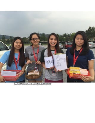 HANDING OVER THE DONATION TO PAWS
 