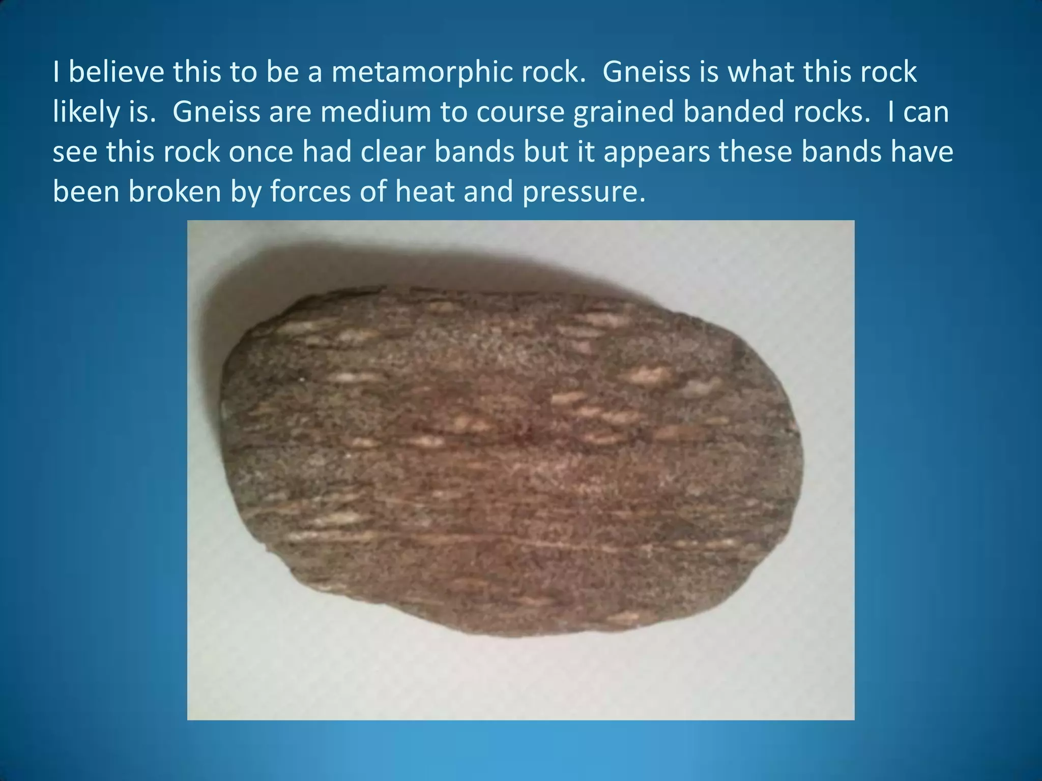 I believe this to be a metamorphic rock. Gneiss is what this rock
likely is. Gneiss are medium to course grained banded rocks. I can
see this rock once had clear bands but it appears these bands have
been broken by forces of heat and pressure.
 