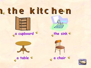 In the kitchen a cupboard a table the sink a chair 