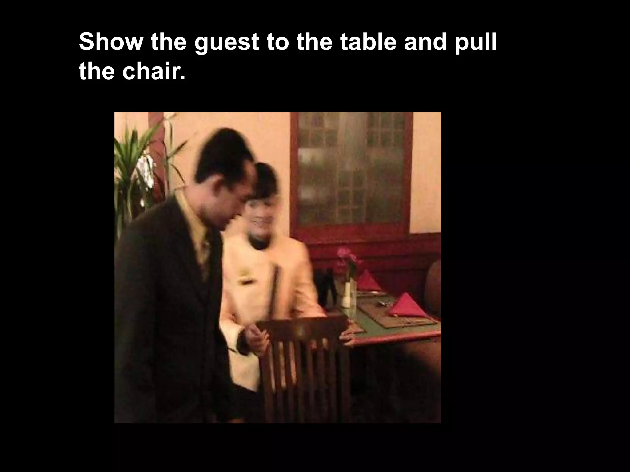 Show the guest to the table and pull the chair. 