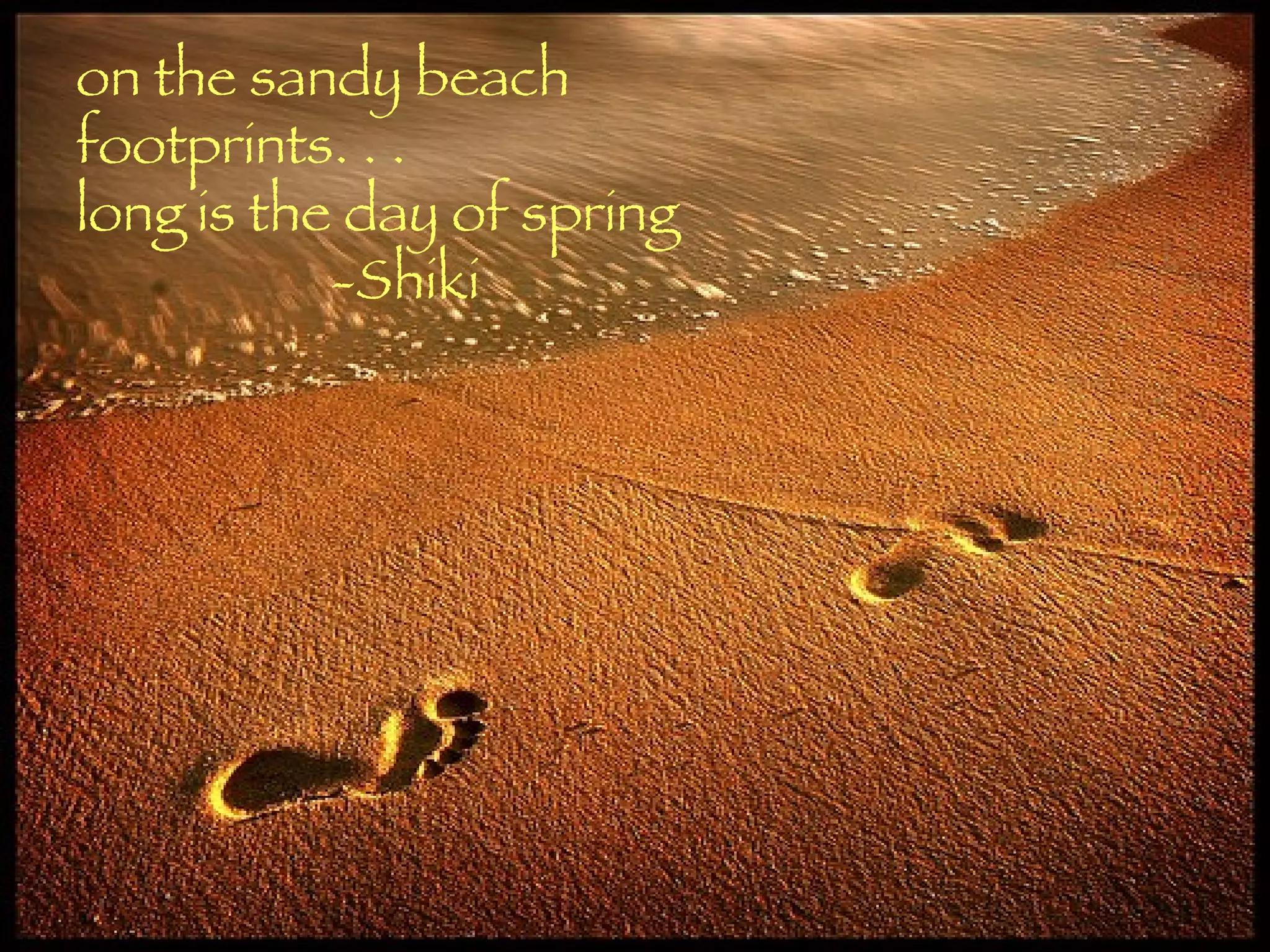 on the sandy beach footprints. . . long is the day of spring -Shiki 