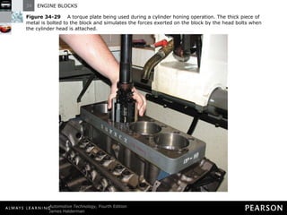 Figure 34-29   A torque plate being used during a cylinder honing operation. The thick piece of metal is bolted to the block and simulates the forces exerted on the block by the head bolts when the cylinder head is attached. 
