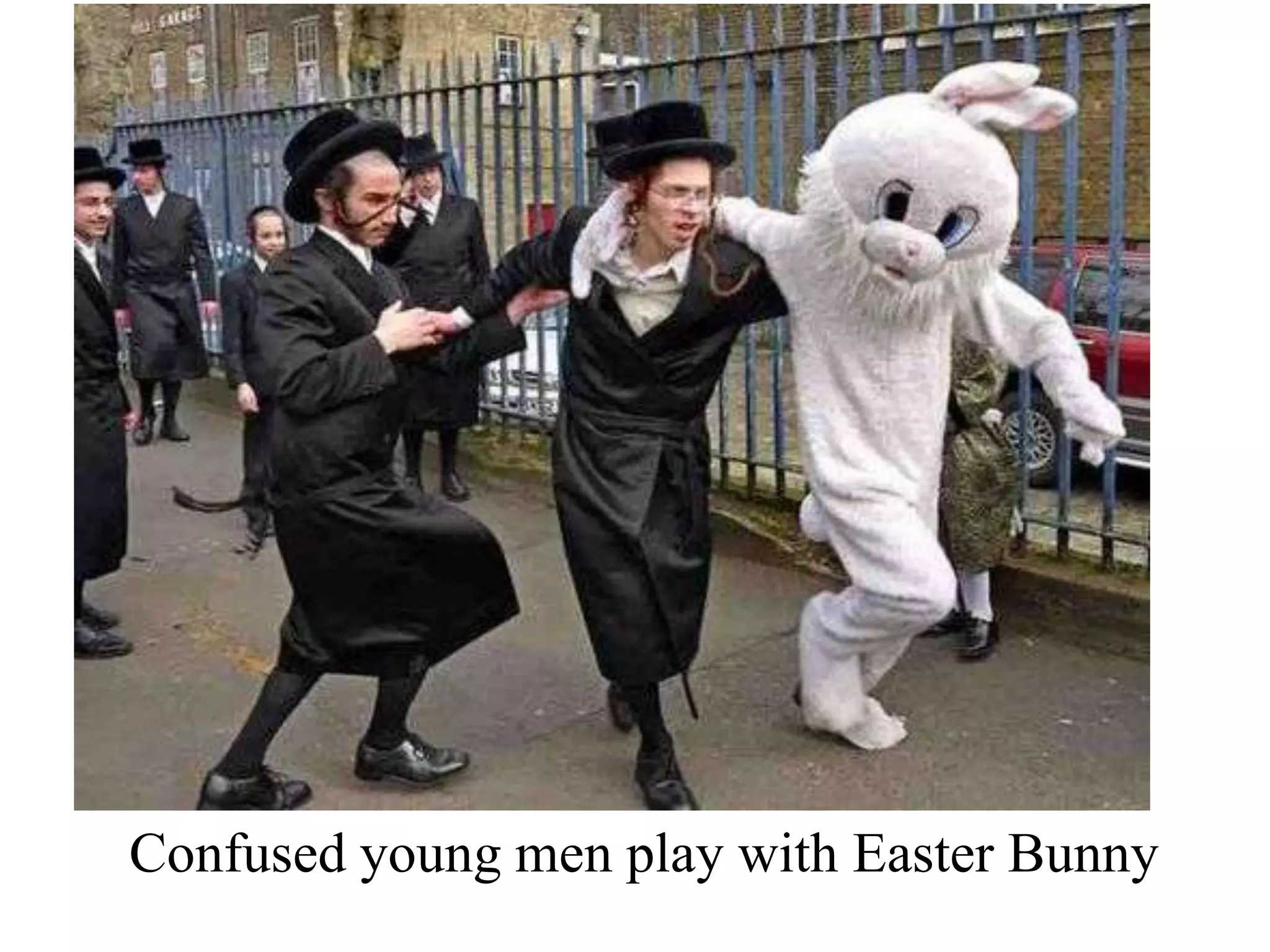 Confused young men play with Easter Bunny

 