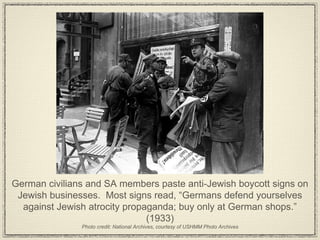 German civilians and SA members paste anti-Jewish boycott signs on Jewish businesses.  Most signs read, “Germans defend yourselves against Jewish atrocity propaganda; buy only at German shops.” (1933) Photo credit: National Archives, courtesy of USHMM Photo Archives 