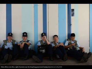 Police officers rest after a night of protests near the Hong Kong government headquarters(Dale de la Rey/AFP) 
 