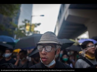 An anti-government protester uses cling film in an effort to protect his eyes from the effects of tear gas(Anthony Kwan/Getty) 
 