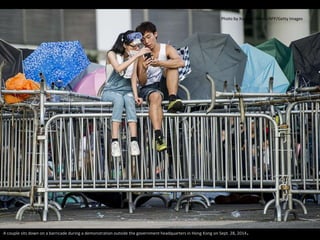 Photo by Xaume Olleros/AFP/Getty Images 
A couple sits down on a barricade during a demonstration outside the government headquarters in Hong Kong on Sept. 28, 2014. 
 