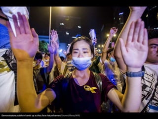 Demonstrators put their hands up as they face riot policemen(Xaume Olleros/AFP) 
 