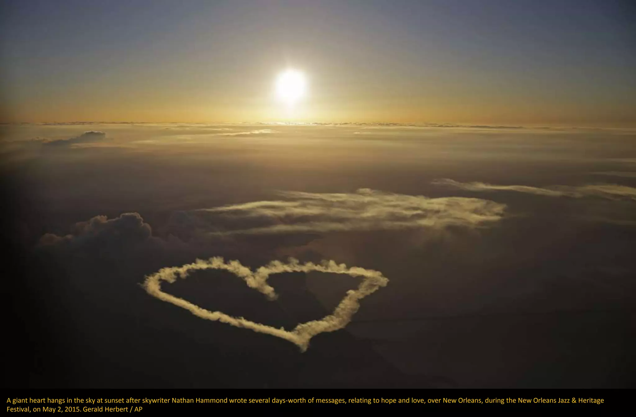 A giant heart hangs in the sky at sunset after skywriter Nathan Hammond wrote several days-worth of messages, relating to hope and love, over New Orleans, during the New Orleans Jazz & Heritage
Festival, on May 2, 2015. Gerald Herbert / AP
 