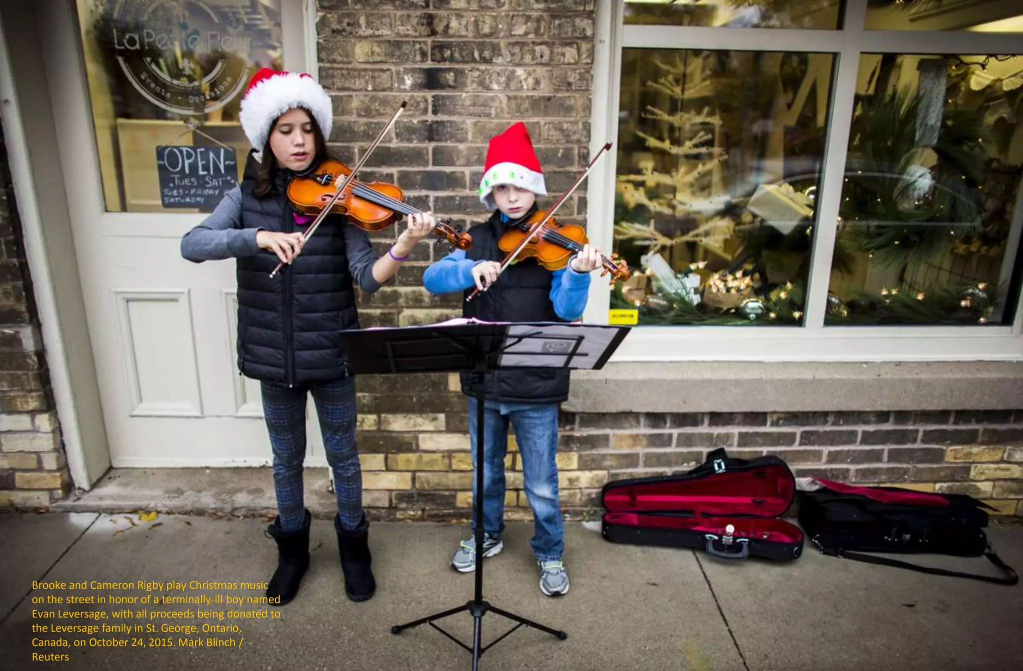 Brooke and Cameron Rigby play Christmas music
on the street in honor of a terminally-ill boy named
Evan Leversage, with all proceeds being donated to
the Leversage family in St. George, Ontario,
Canada, on October 24, 2015. Mark Blinch /
Reuters
 