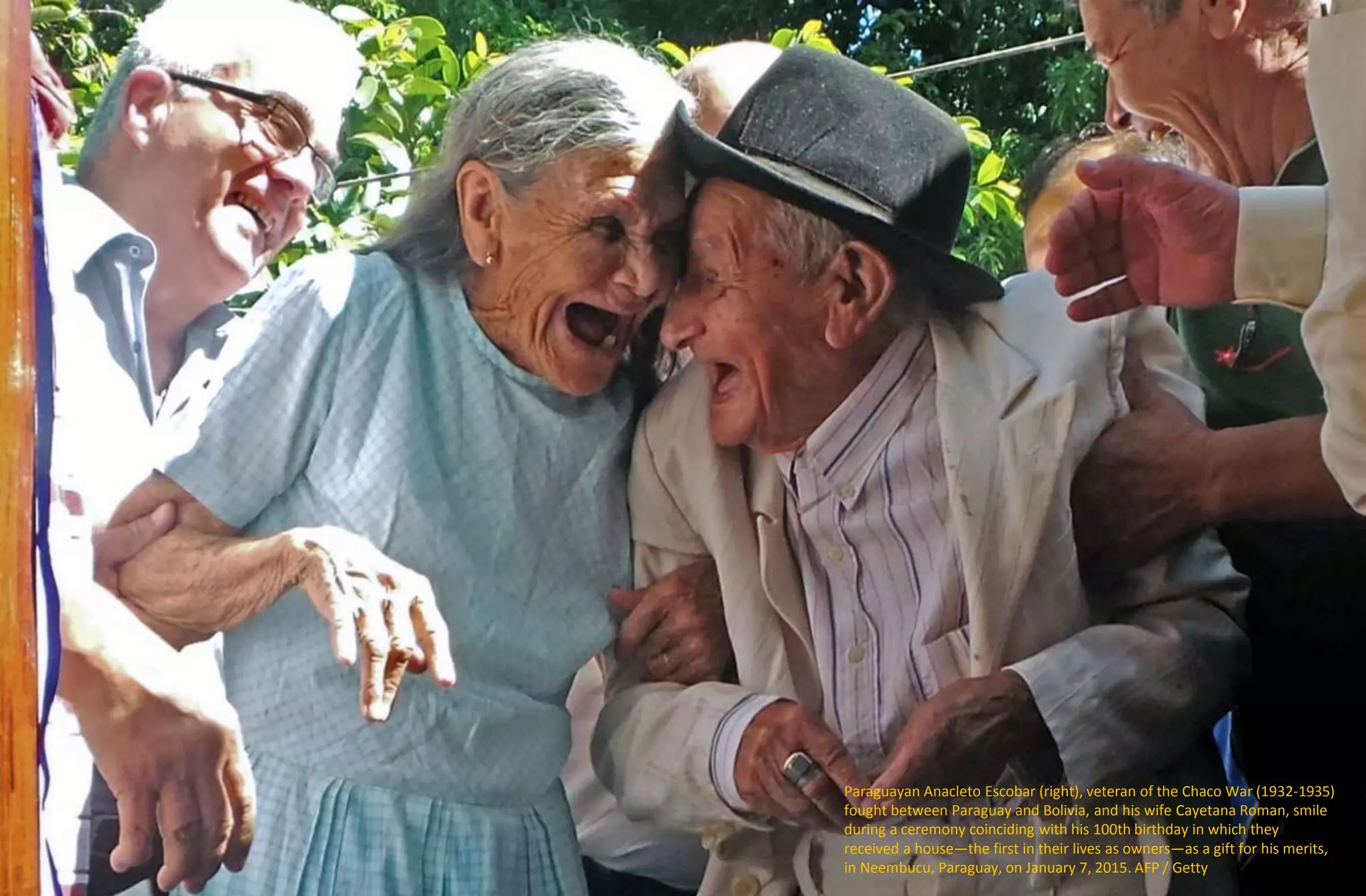 Paraguayan Anacleto Escobar (right), veteran of the Chaco War (1932-1935)
fought between Paraguay and Bolivia, and his wife Cayetana Roman, smile
during a ceremony coinciding with his 100th birthday in which they
received a house—the first in their lives as owners—as a gift for his merits,
in Neembucu, Paraguay, on January 7, 2015. AFP / Getty
 
