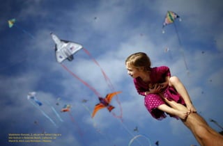 Madeleine Klonoski, 2, sits on her father's leg at a
kite festival in Redondo Beach, California, on
March 8, 2015. Lucy Nicholson / Reuters
 