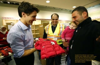 Canada's Prime Minister Justin Trudeau
presents Syrian refugees with a child's winter
jacket, after their arrival from Beirut at the
Toronto Pearson International Airport in
Mississauga, Ontario, on December 11, 2015.
Mark Blinch / Reuters
 