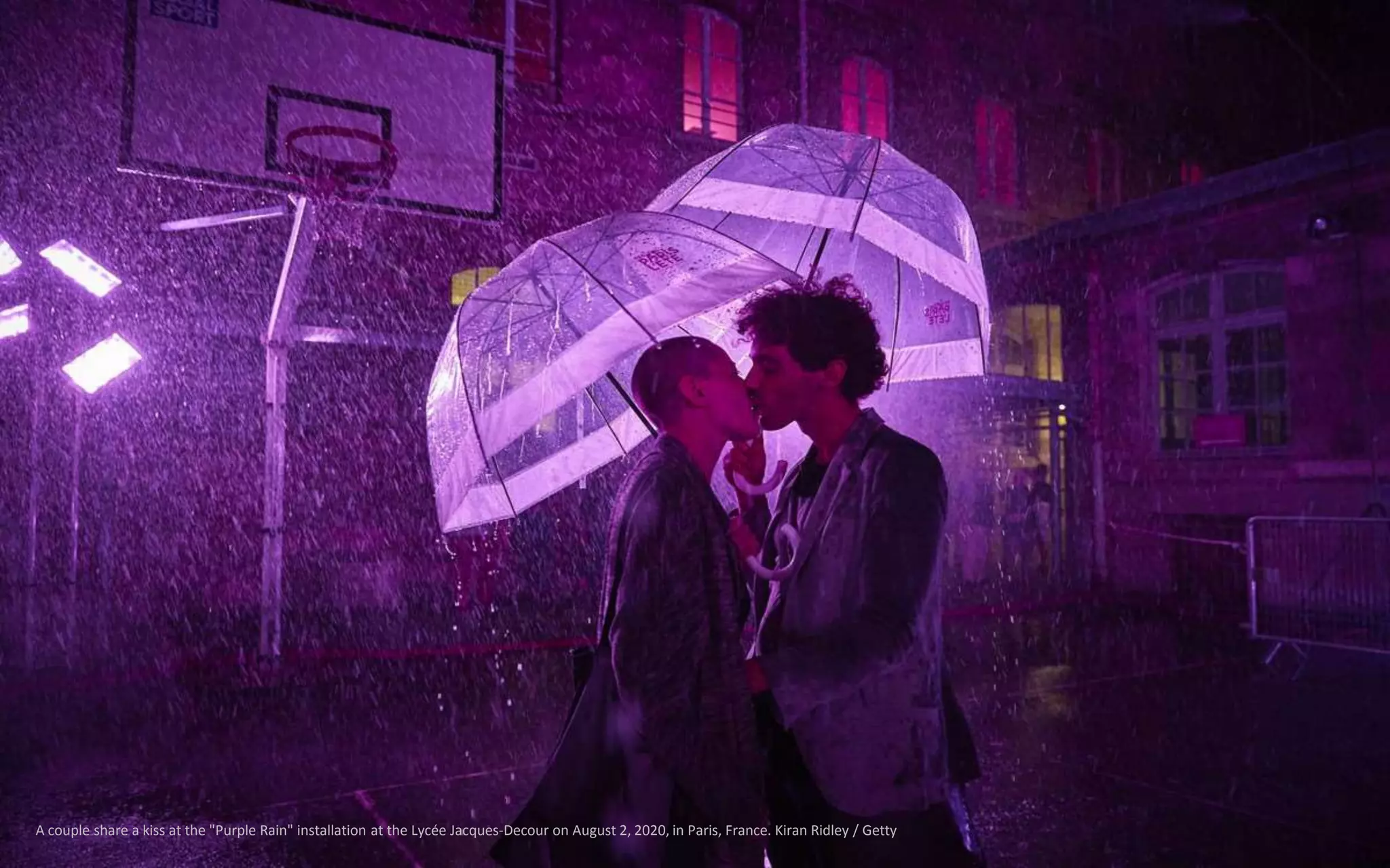A couple share a kiss at the "Purple Rain" installation at the Lycée Jacques-Decour on August 2, 2020, in Paris, France. Kiran Ridley / Getty
 