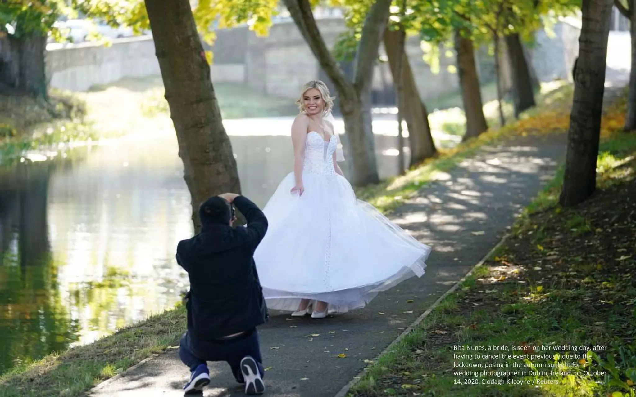 Rita Nunes, a bride, is seen on her wedding day, after
having to cancel the event previously due to the
lockdown, posing in the autumn sunlight for a
wedding photographer in Dublin, Ireland, on October
14, 2020. Clodagh Kilcoyne / Reuters
 