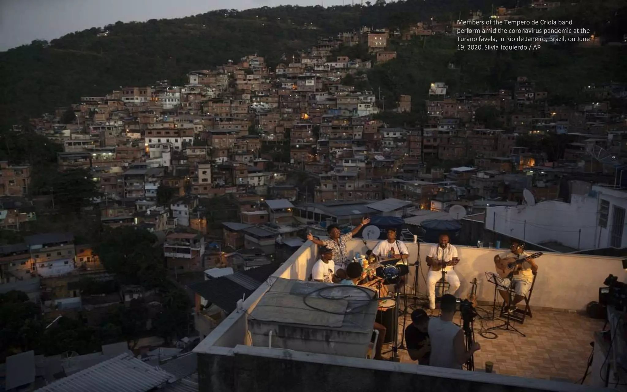 Members of the Tempero de Criola band
perform amid the coronavirus pandemic at the
Turano favela, in Rio de Janeiro, Brazil, on June
19, 2020. Silvia Izquierdo / AP
 