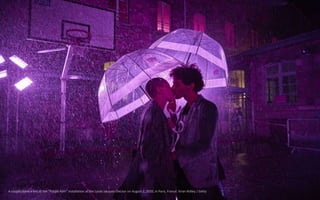 A couple share a kiss at the "Purple Rain" installation at the Lycée Jacques-Decour on August 2, 2020, in Paris, France. K...