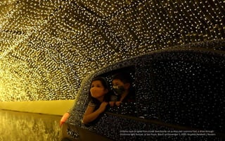Children look at lights from inside their family car as they visit Luminna Fest, a drive-through
Christmas light festival,...