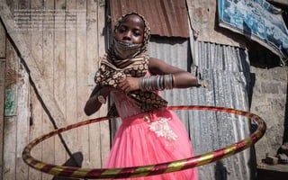 An orphan plays with her new Hula-Hoop during a food-
and-toy-distribution event for about 500 orphans in 11
orphanages, c...