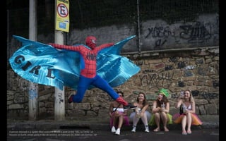 A person dressed in a Spider-Man costume strikes a pose at the “Ceu na Terra,” or
Heaven on Earth, street party in Rio de ...