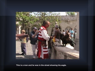 This is a man and he was in the street showing his eagle.
 