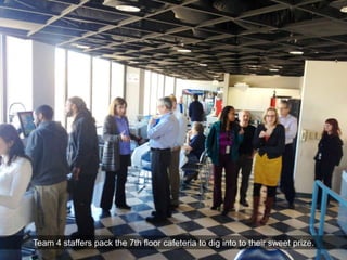Team 4 staffers pack the 7th floor cafeteria to dig into to their sweet prize.
 