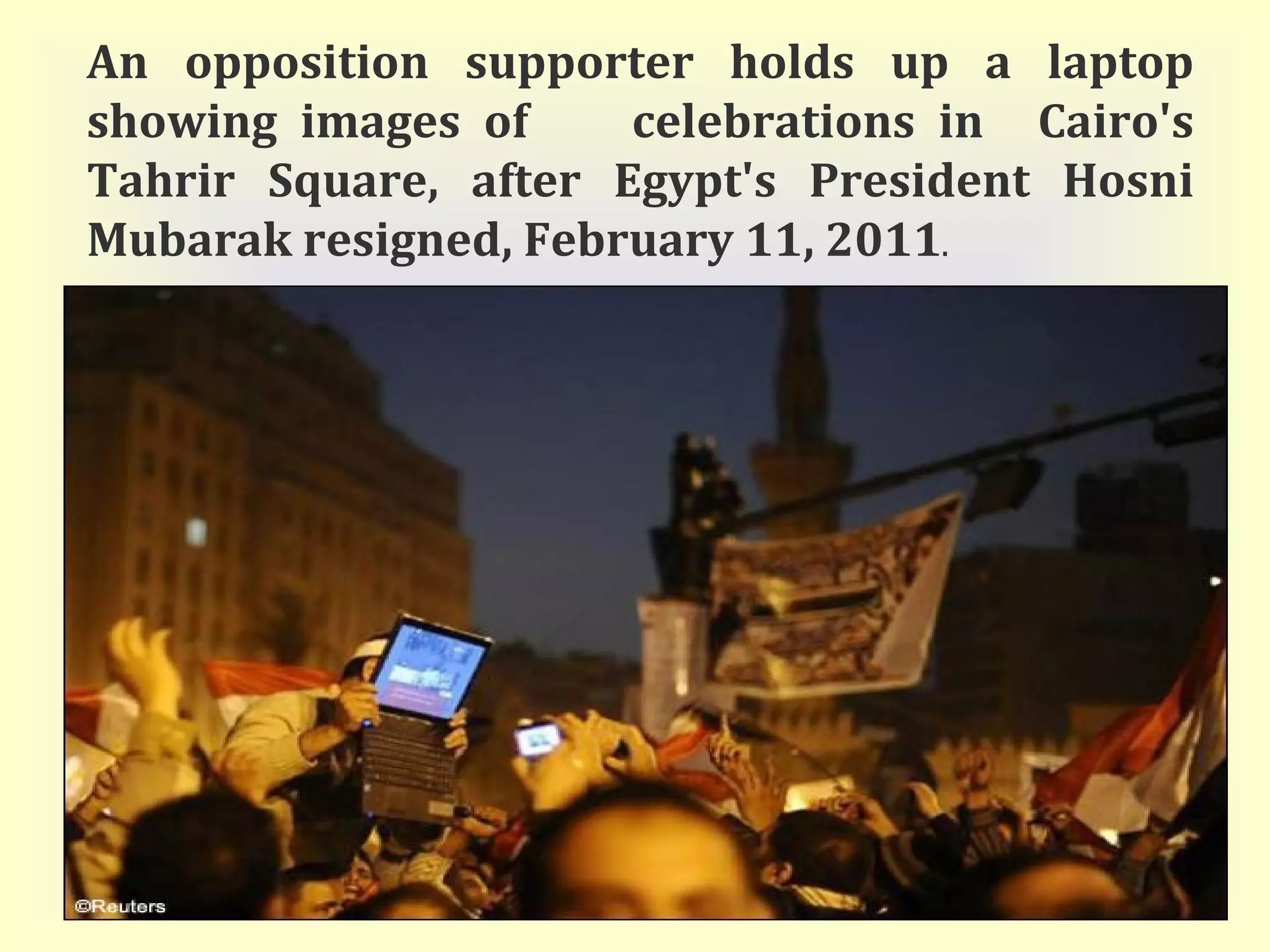 An opposition supporter holds up a laptop showing images of  celebrations in  Cairo's Tahrir Square, after Egypt's President Hosni Mubarak resigned, February 11, 2011 . 