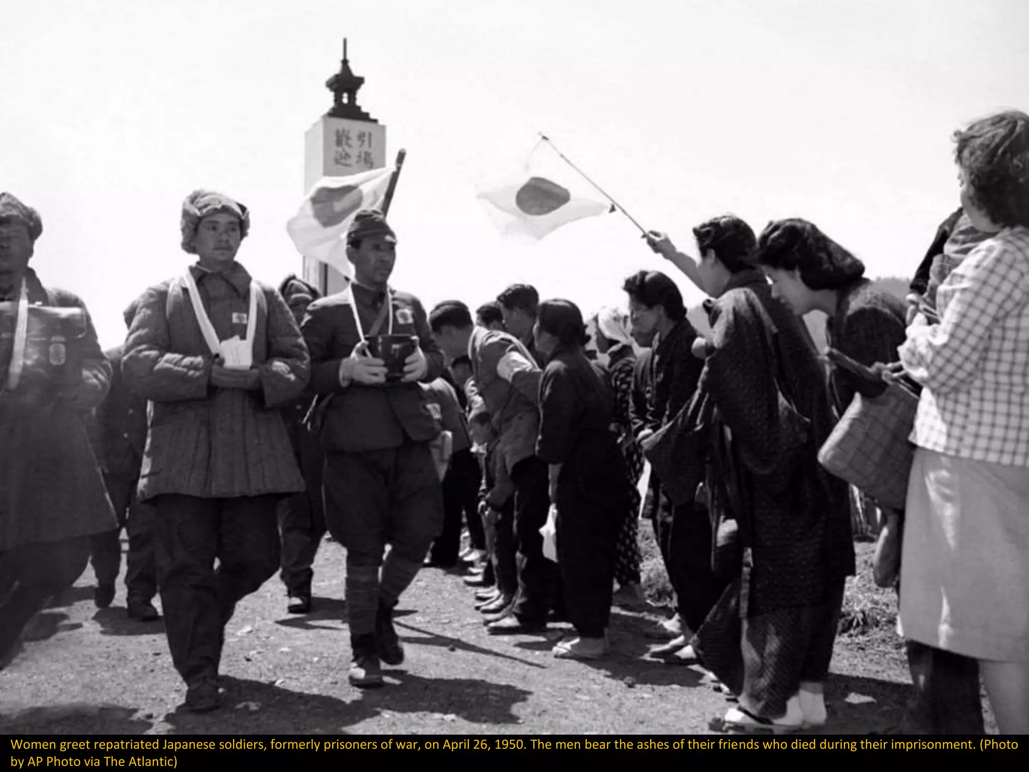 Women greet repatriated Japanese soldiers, formerly prisoners of war, on April 26, 1950. The men bear the ashes of their friends who died during their imprisonment. (Photo
by AP Photo via The Atlantic)
 