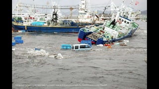 Fishing boats and vehicles are swept away by a tsunami wave at Onahama port in Iwaki city, Fukushima prefectureJiji Press/...