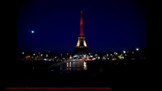 A picture taken on March 22, 2016 shows the Eiffel Tower in Paris illuminated in colours of the Belgian flag in tribute to the victims of terrorist attacks in Brussels.
 