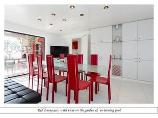Red dining area with view on the garden & swimming pool

 
